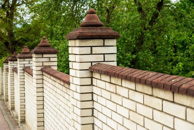 Elegant compound wall construction in Bangalore, showcasing sturdy brick pillars and detailed design
